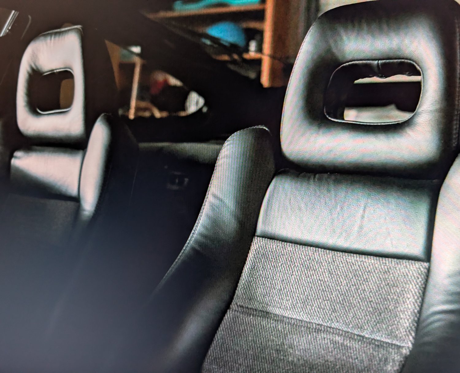 Black leather Honda CRX interior, close on the backs of the front seats